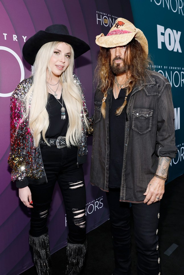 NASHVILLE, TENNESSEE - AUGUST 23: (L-R) FIREROSE and Billy Ray Cyrus attend the 16th Annual Academy of Country Music Honors at Ryman Auditorium on August 23, 2023 in Nashville, Tennessee. (Photo by Jason Kempin/Getty Images for ACM) 13626375 EXCLUSIVE: The surprising secret past of Billie Ray Cyrus's Aussie wife Firerose - and how she once looked very VERY different 13744963 13802967